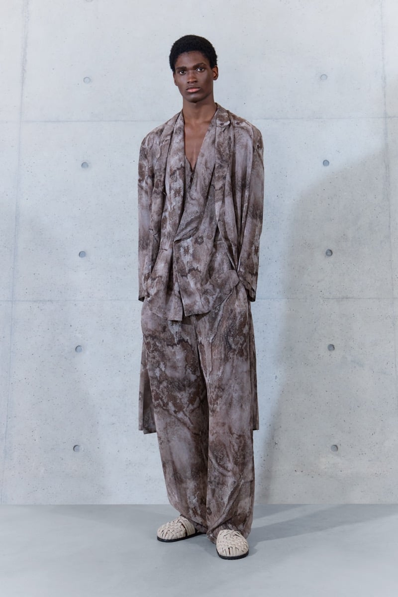 A model in a mottled print draped jacket with matching wide-leg trousers, for Emporio Armani's spring-summer 2027 collection