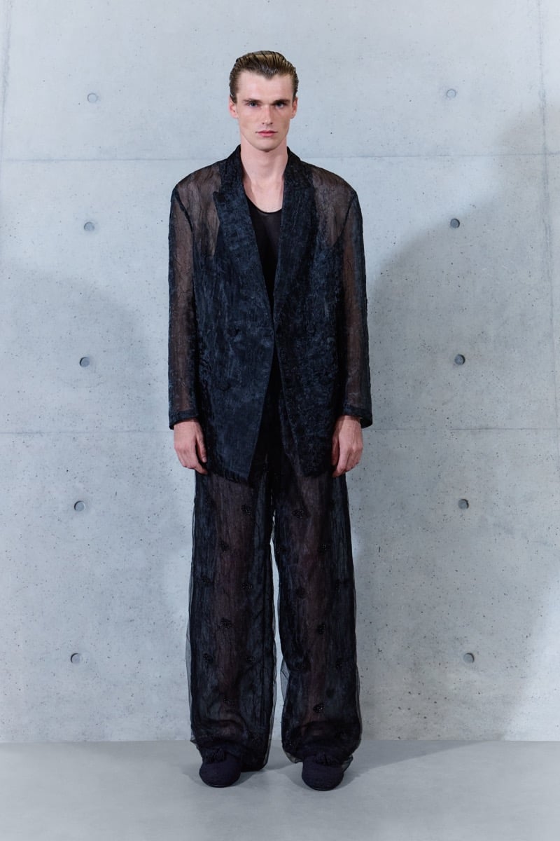 A model in a sheer organza double-breasted jacket with matching sheer trousers, for Emporio Armani's spring-summer 2027 collection