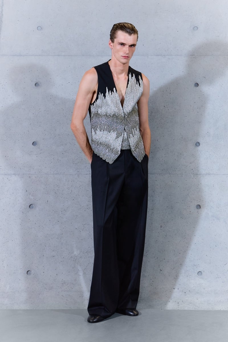 A model in a silver embellished waistcoat with pleated wide-leg trousers, for Emporio Armani's spring-summer 2027 collection