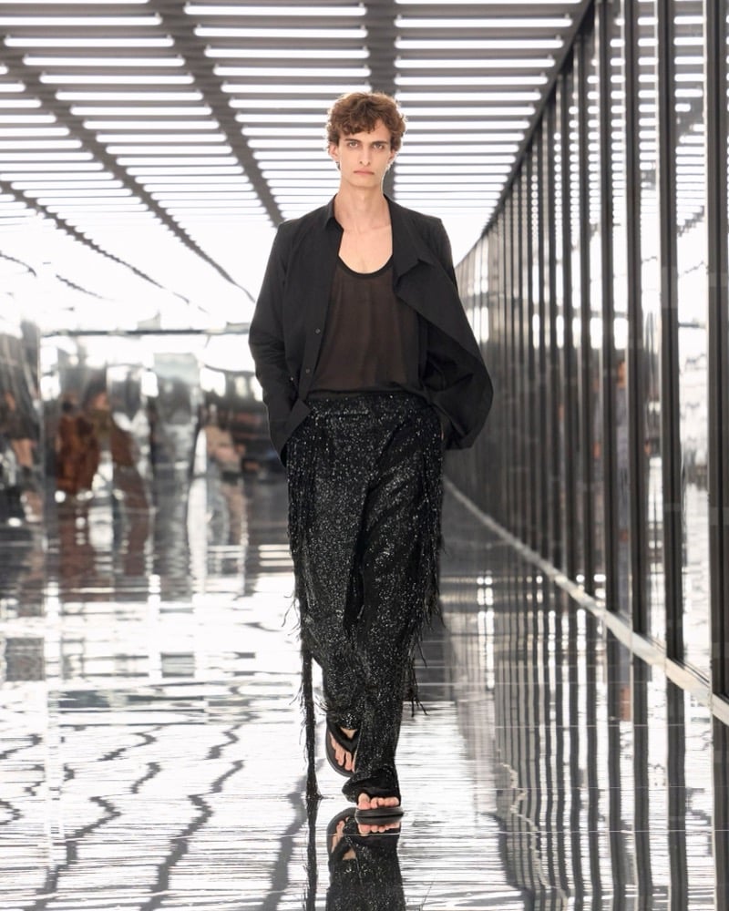 A model in a lightweight jacket over a sheer tank, with embellished fringed trousers, for Fendi's spring-summer 2027 collection