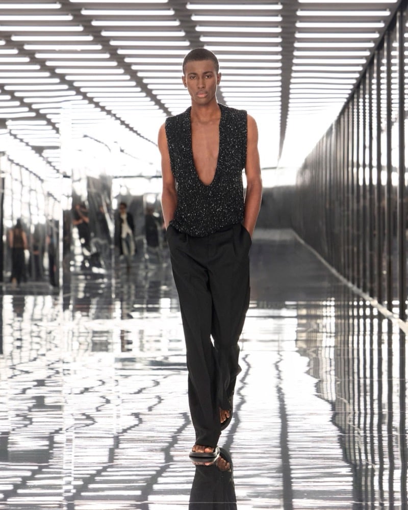 A model in a plunging speckled knit vest with pleated trousers, for Fendi's spring-summer 2027 collection