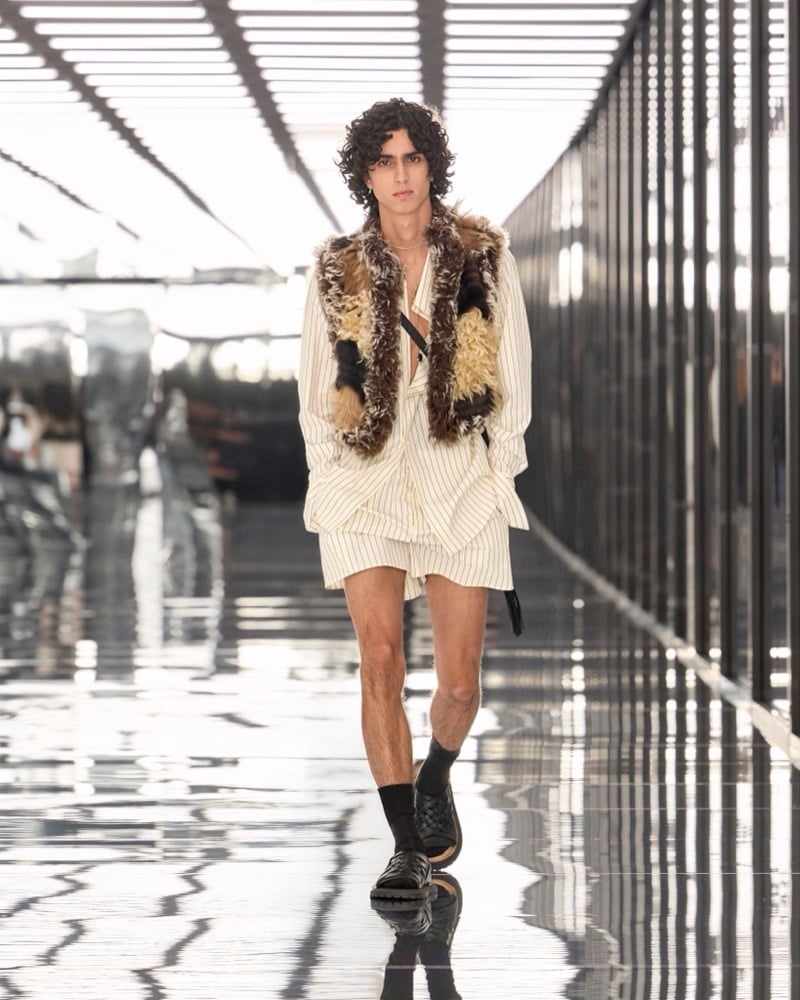 A model in a shaggy patchwork vest over a pinstripe shirt with matching shorts, for Fendi's spring-summer 2027 collection