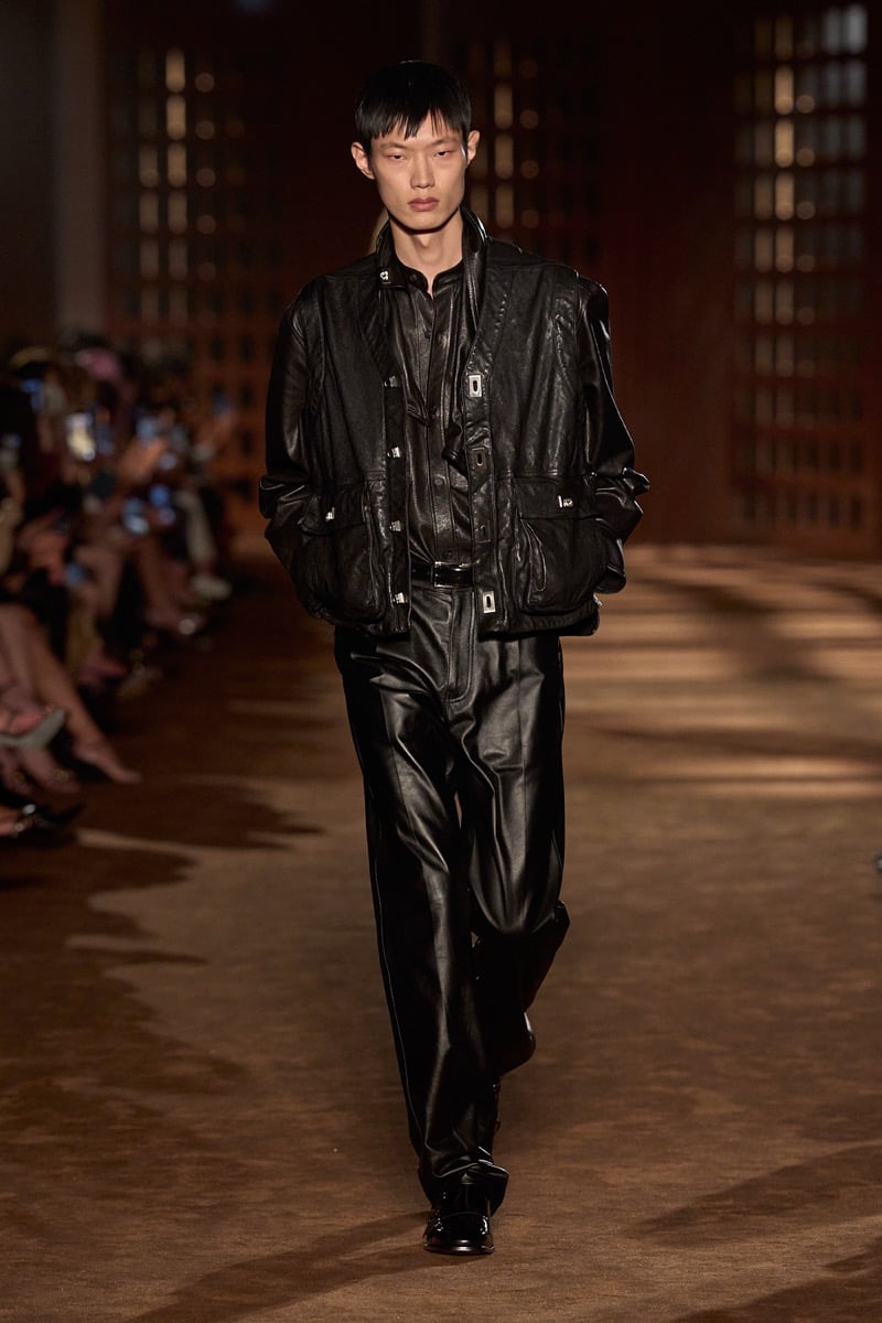 A model in a leather jacket over a leather shirt and leather trousers, for Ferragamo's spring-summer 2027 collection