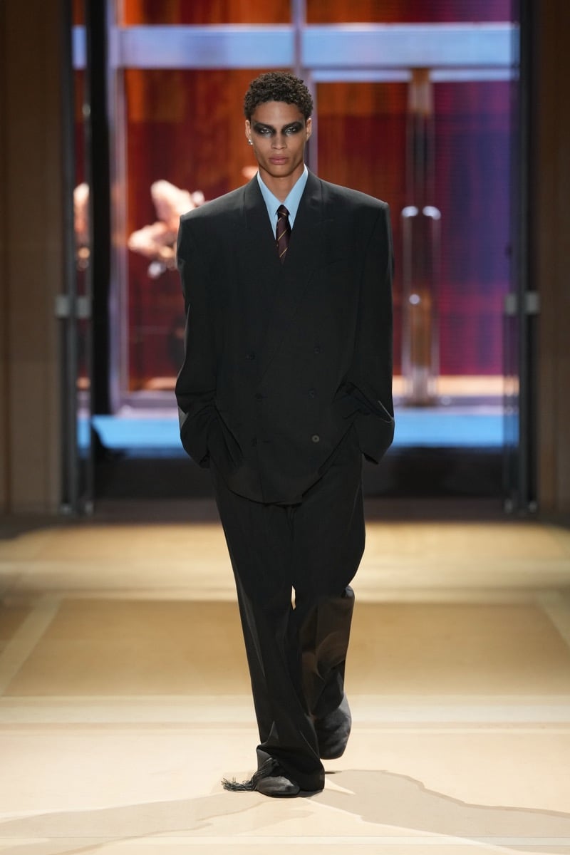 A model in an oversized double-breasted suit over a light blue shirt and striped tie, for Gucci's spring-summer 2027 collection