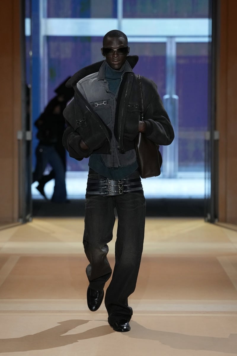 A model in a puffed denim jacket with a shearling collar and Horsebit pockets, with a triple Horsebit belt, for Gucci's spring-summer 2027 collection