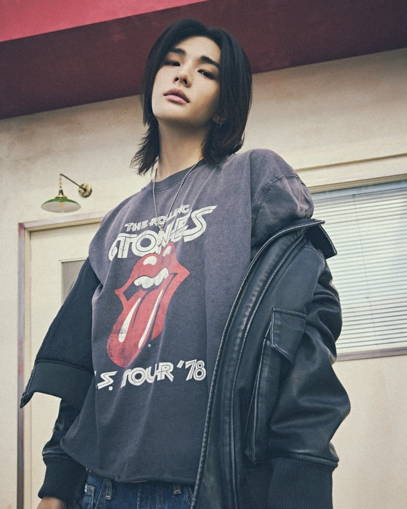 Hyunjin wears a washed gray Rolling Stones US Tour '78 T-shirt with the tongue logo under a black leather jacket, a chain necklace at his throat, for GUESS JEANS x The Rolling Stones