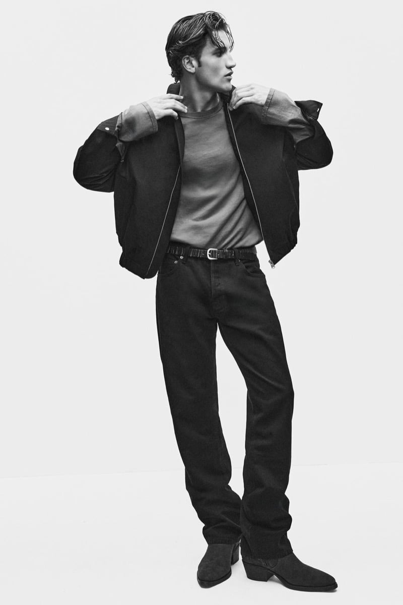 Max Knott pulls on a zip jacket over a sweatshirt and jeans for Zara's 90's Archive