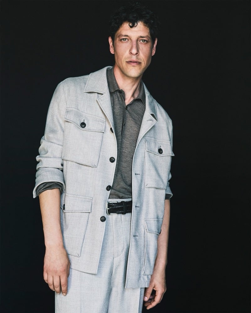 Itshak Vanunu wears a light gray cotton jacket with four flap pockets over a polo shirt for Pal Zileri's fall-winter 2026 campaign.