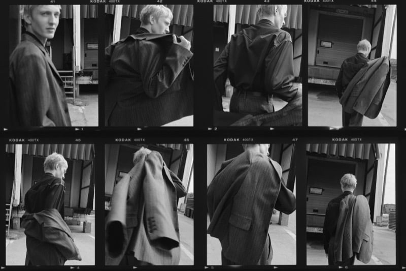 Contact sheet of Pierrick Grégoire slinging a pinstripe suit jacket over his shoulder outside a loading dock