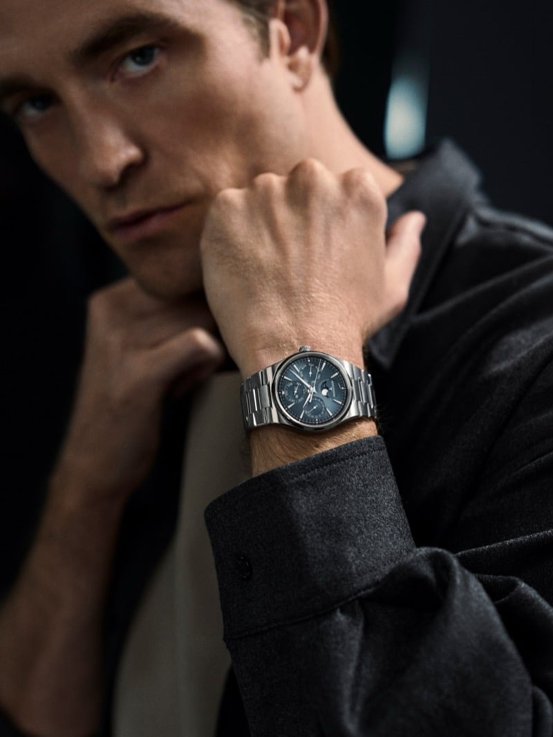 Close-up of Robert Pattinson resting his chin on his fist, the Jaeger-LeCoultre Master Control Chronometre Perpetual Calendar in focus on his wrist