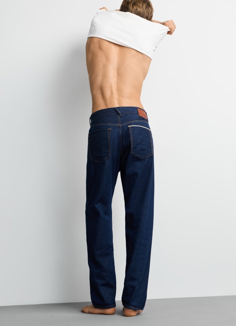 Samuel Curtis pulls off his tee to reveal the back pockets and leather patch on Pepe Jeans' Dalston selvedge jean