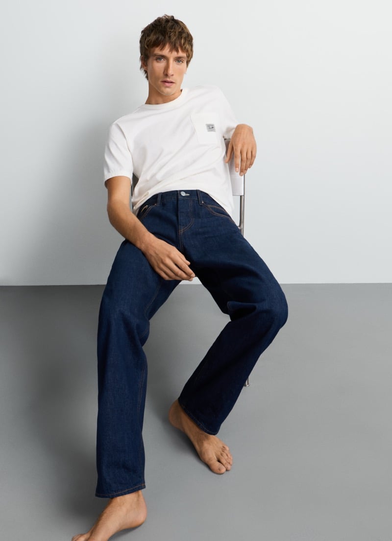 Samuel Curtis sits in a pocket tee and Pepe Jeans' straight-leg Dalston selvedge jean