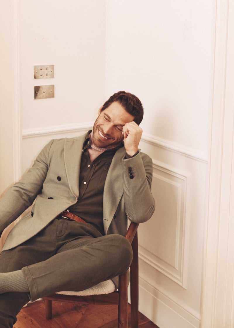 Simone Bredariol laughing in a sage-green blazer over an olive polo with matching trousers, for Boglioli's fall-winter 2026 campaign