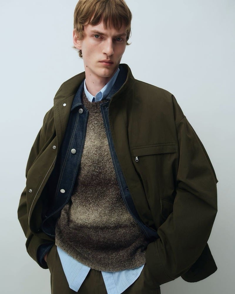 Tammo Rahming in an olive field jacket layered over a denim jacket, fuzzy ombré sweater, and striped shirt