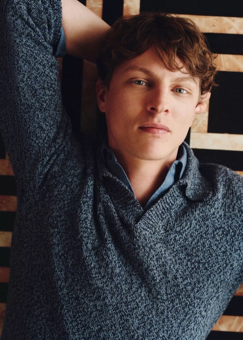 Tim Schuhmacher rests his head back in a textured knit polo shirt over a chambray collar, for Mango's Superior Denim collection