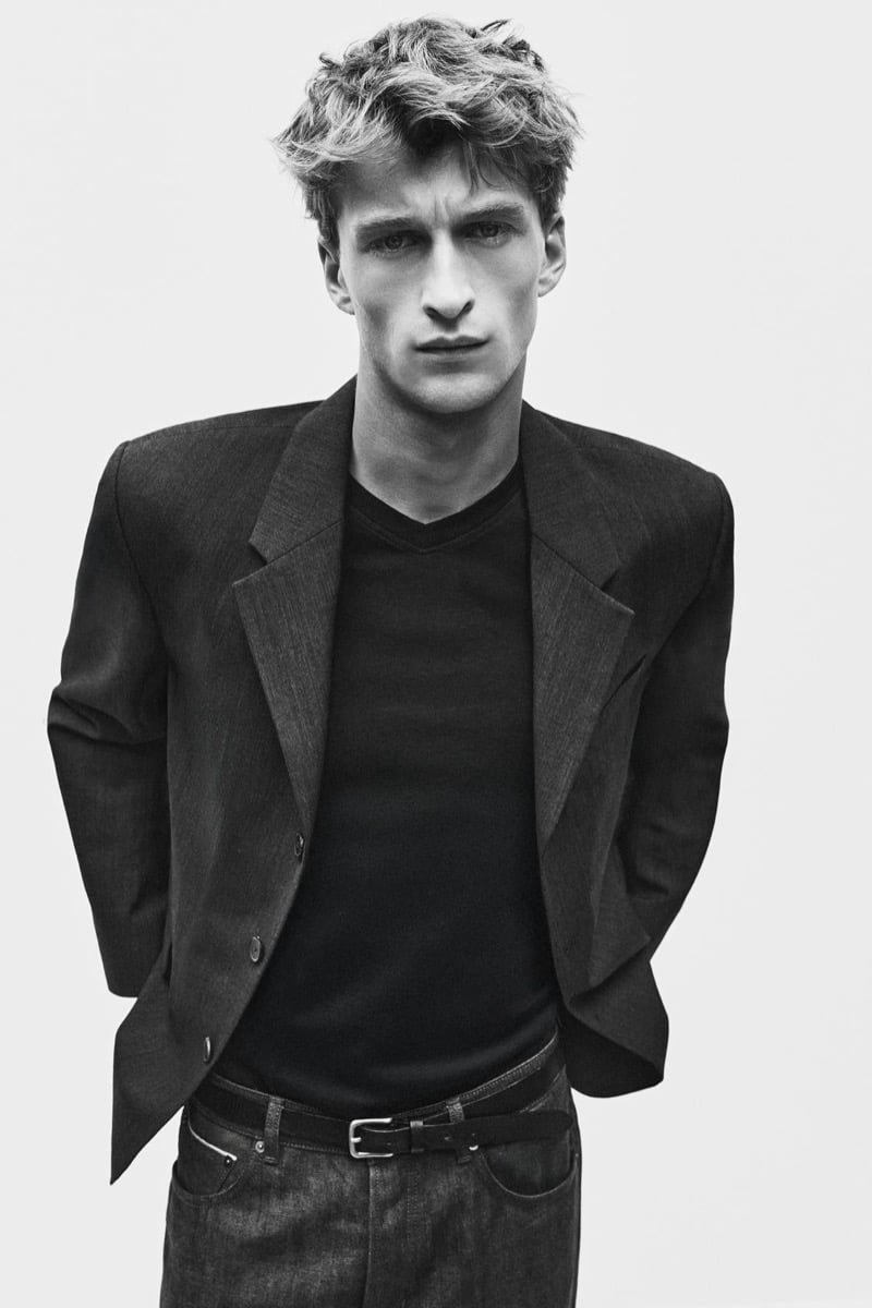 Vasko Luyckx in a broad-shouldered blazer over a dark v-neck tee and jeans for Zara's 90's Archive