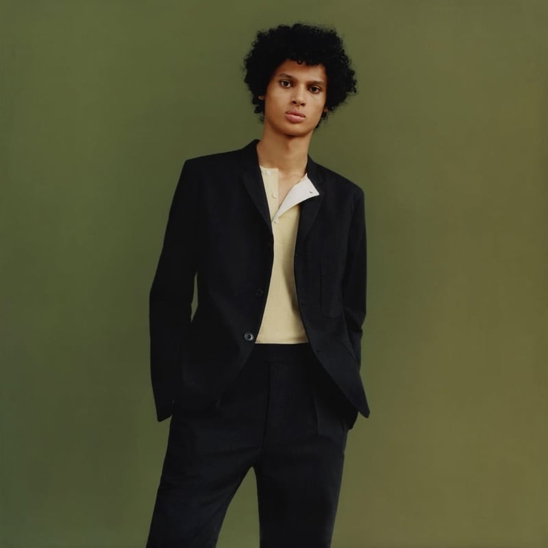 Uniqlo and Lemaire spring 2016 black suit with a pale henley.