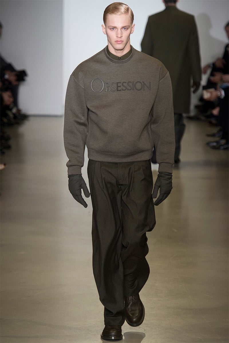 Calvin Klein Collection fall 2014 Obsession sweatshirt with loose tailored trousers and gloves.