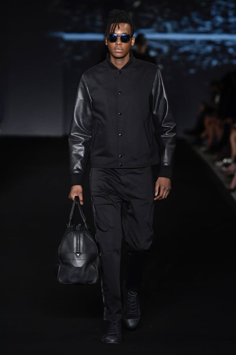 rag & bone spring 2017 black varsity jacket with leather sleeves, black trousers and a bag.