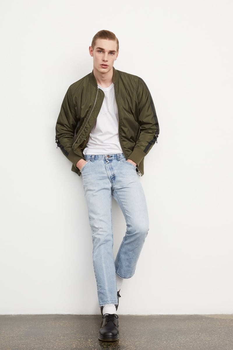 Stampd and Monkey Time 2015 olive bomber jacket with a white T-shirt and pale jeans.