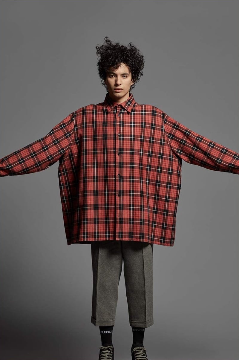 Liam Samuels wears an oversized Raf Simons tartan shirt and wide cropped trousers for Mr Porter in 2018.