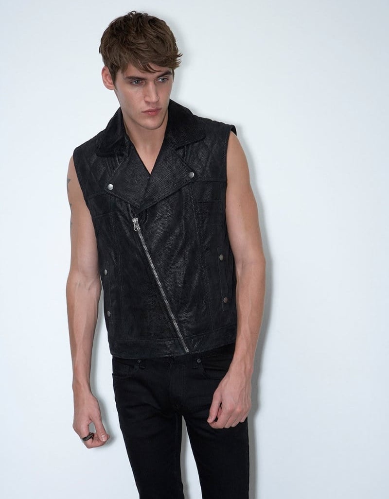 Isaac Carew wears a black sleeveless leather biker jacket and black jeans for Topman AAA in 2011.