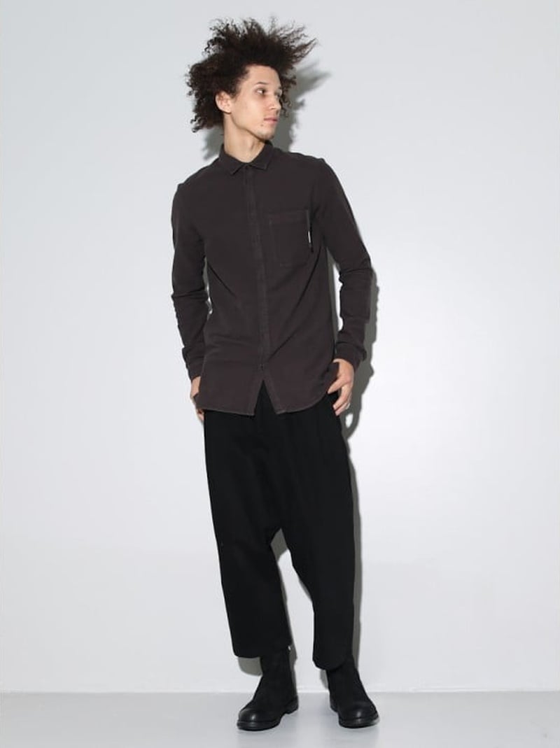 Abiah Hostvedt wears a long dark shirt, loose cropped black trousers and black boots from Silent by Damir Doma for Oak in 2013.