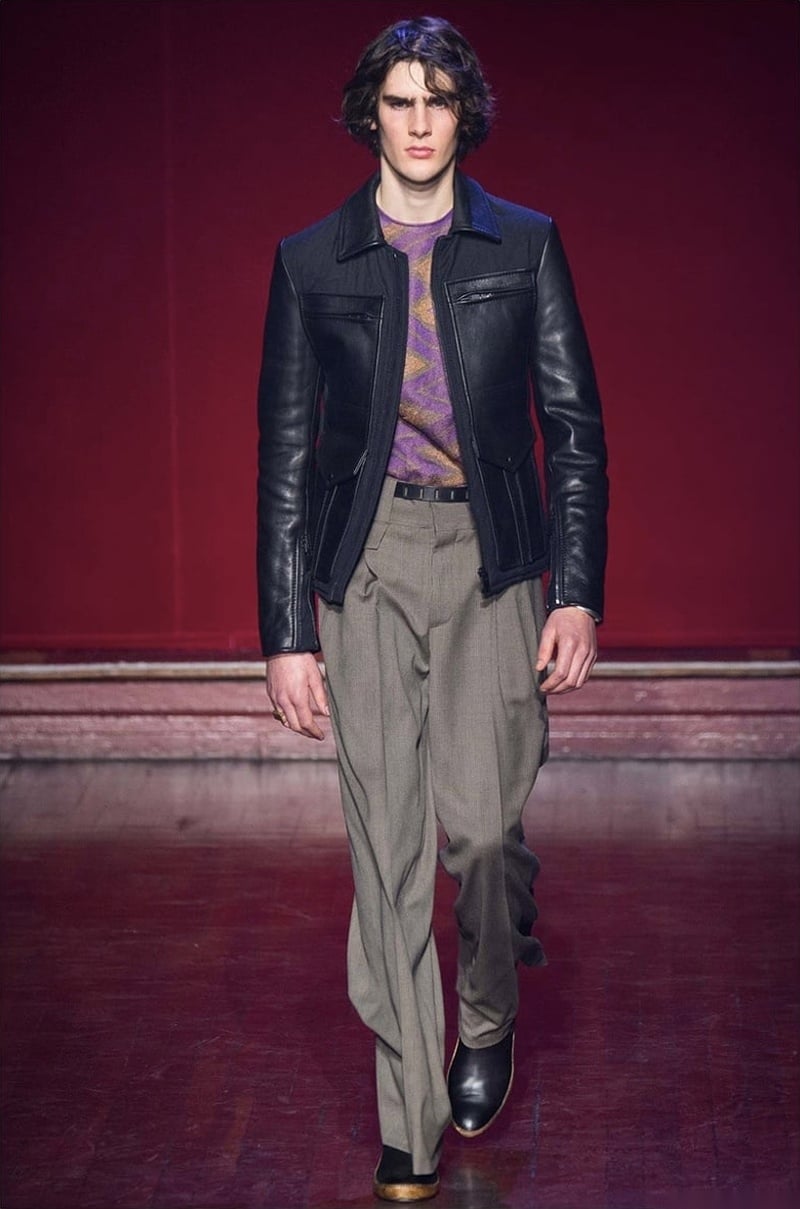 Maison Margiela fall 2015 runway look with a leather jacket, patterned knitwear and loose high-waisted trousers.
