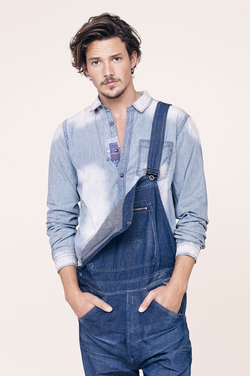 Rob Moore wears denim overalls and a bleached shirt for Replay spring 2015.
