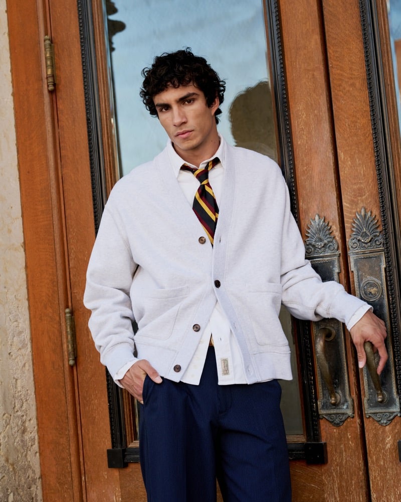 Duncan Yair pairs Abercrombie & Fitch’s heritage heavyweight cardigan with a striped tie and navy trousers.