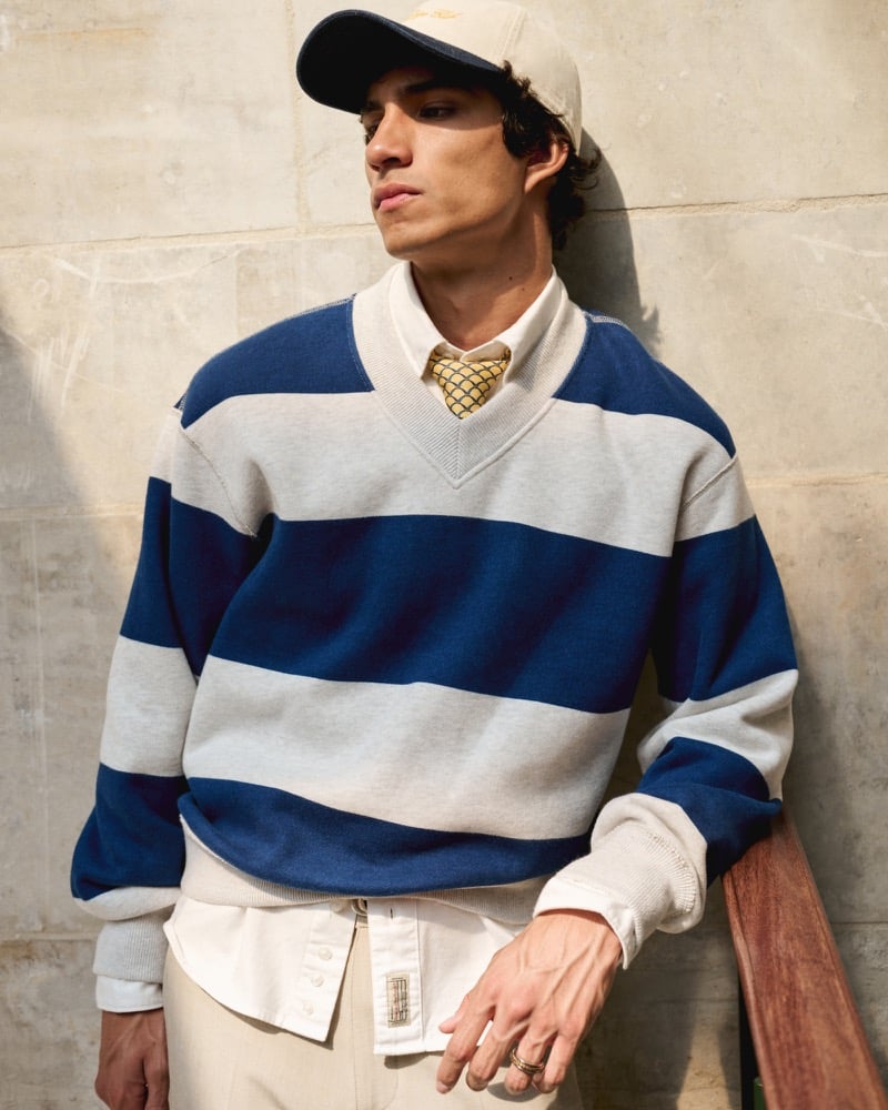 Duncan Yair layers Abercrombie & Fitch’s navy-striped heritage heavyweight V-neck sweatshirt over a white shirt and patterned tie.