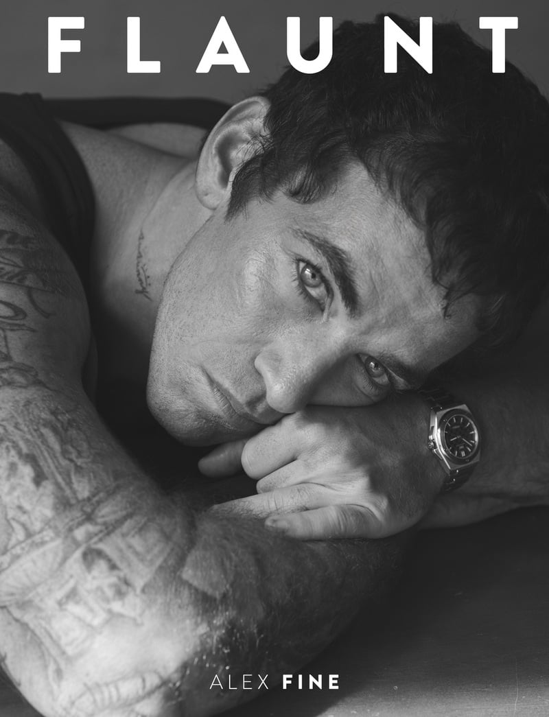Alex Fine rests his head on his arm on the black-and-white Flaunt cover, wearing a tank top and IWC watch.