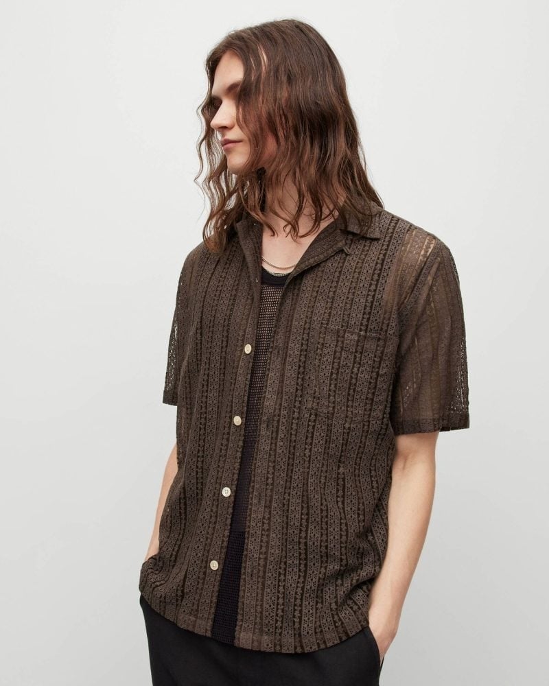 AllSaints’ Cala shirt reveals the black layer beneath it, making transparency part of an everyday short-sleeve shape in 2023.
