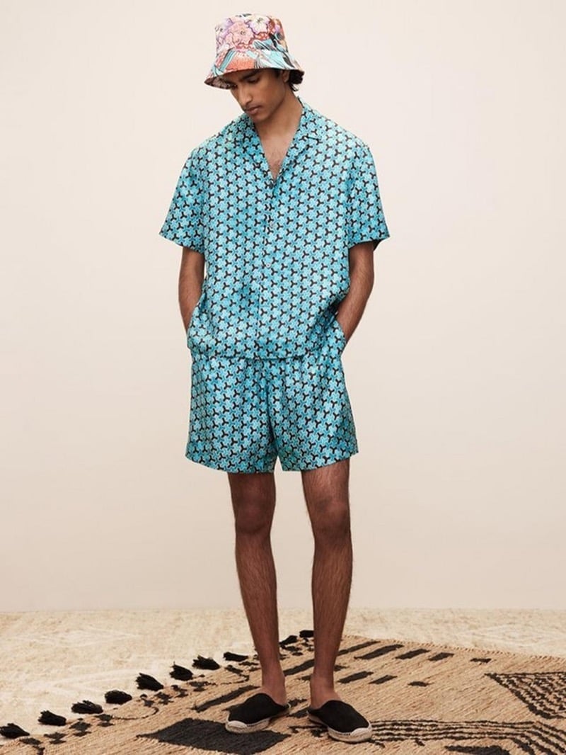 Jeenu Mahadevan wears a matching printed shirt and shorts from Banana Republic’s 2025 collaboration with The White Lotus.