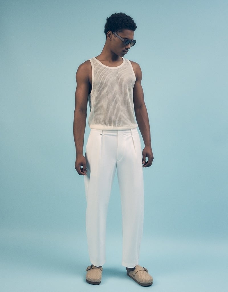 A sheer tank and pleated trousers from Bershka’s summer 2024 range combine exposure with a tailored lower half.