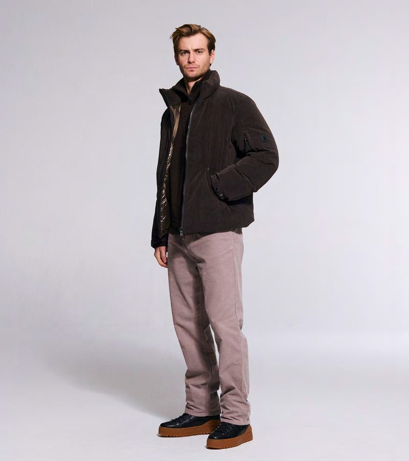 Ben Allen wears a dark textured jacket with dusty pink trousers and brown shoes. Bogner fall-winter 2026 collection.