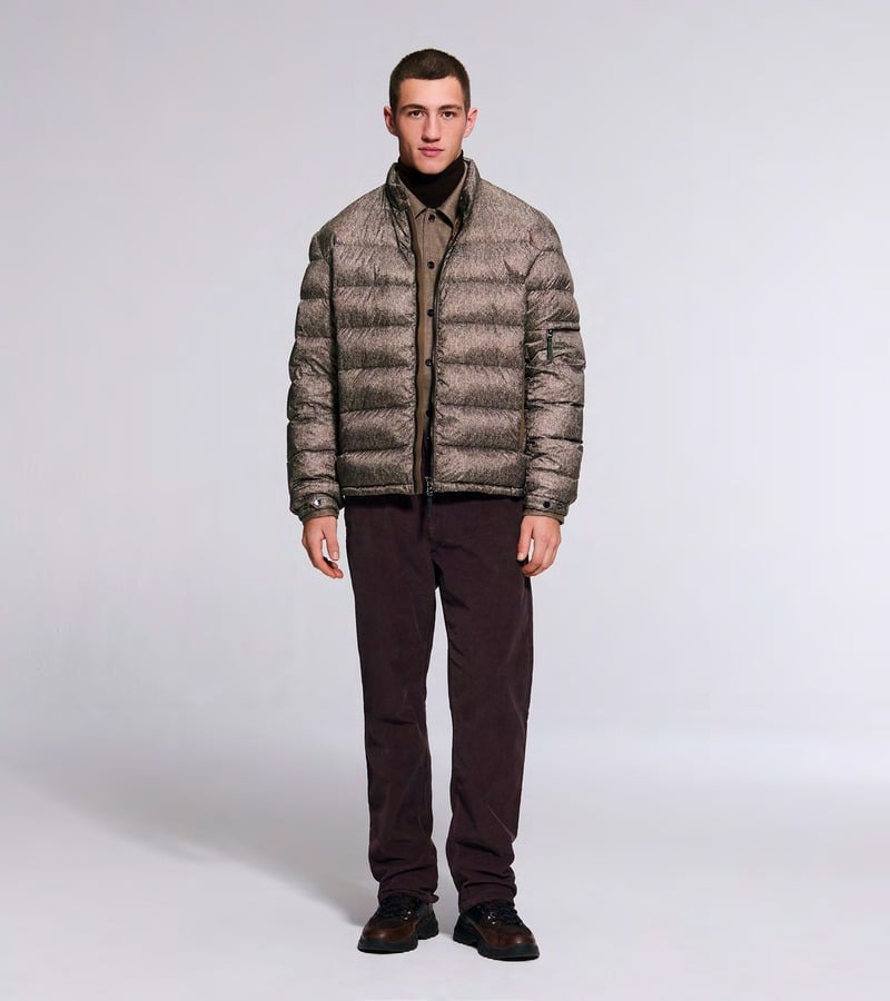A model wears a brown quilted jacket with burgundy trousers and dark shoes. Bogner fall-winter 2026 collection.