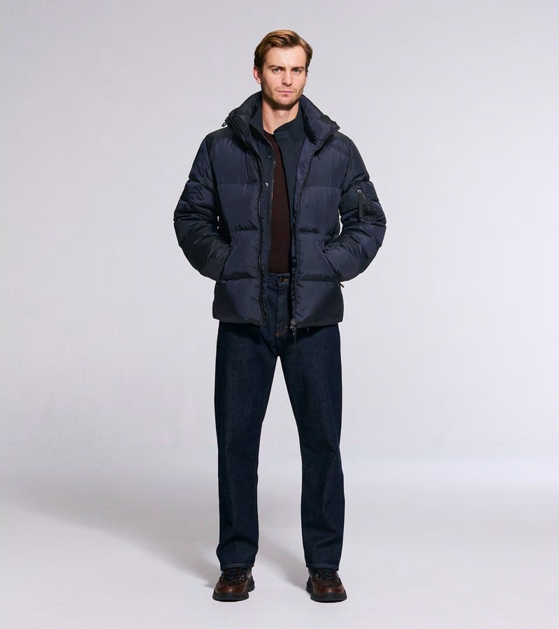 Ben Allen wears a navy padded jacket with matching trousers and brown shoes. Bogner fall-winter 2026 collection.
