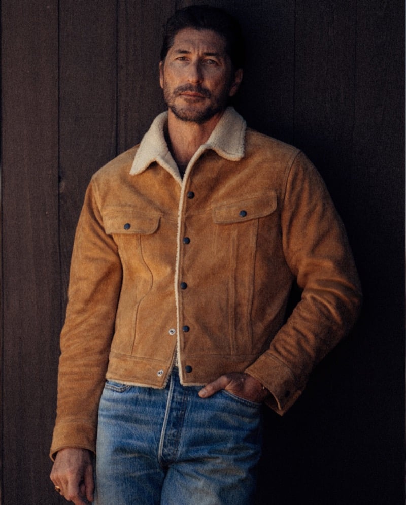 Ryan Porter wears a shearling-collared trucker jacket with jeans.