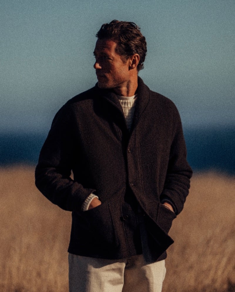 Jon Paul Phillips wears a shawl-collar coat over a cable-knit sweater.