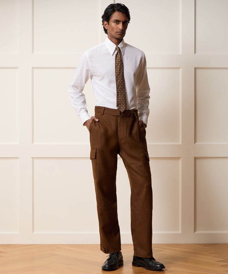 White shirt and patterned tie with brown belted cargo pants and black leather shoes from Todd Snyder.