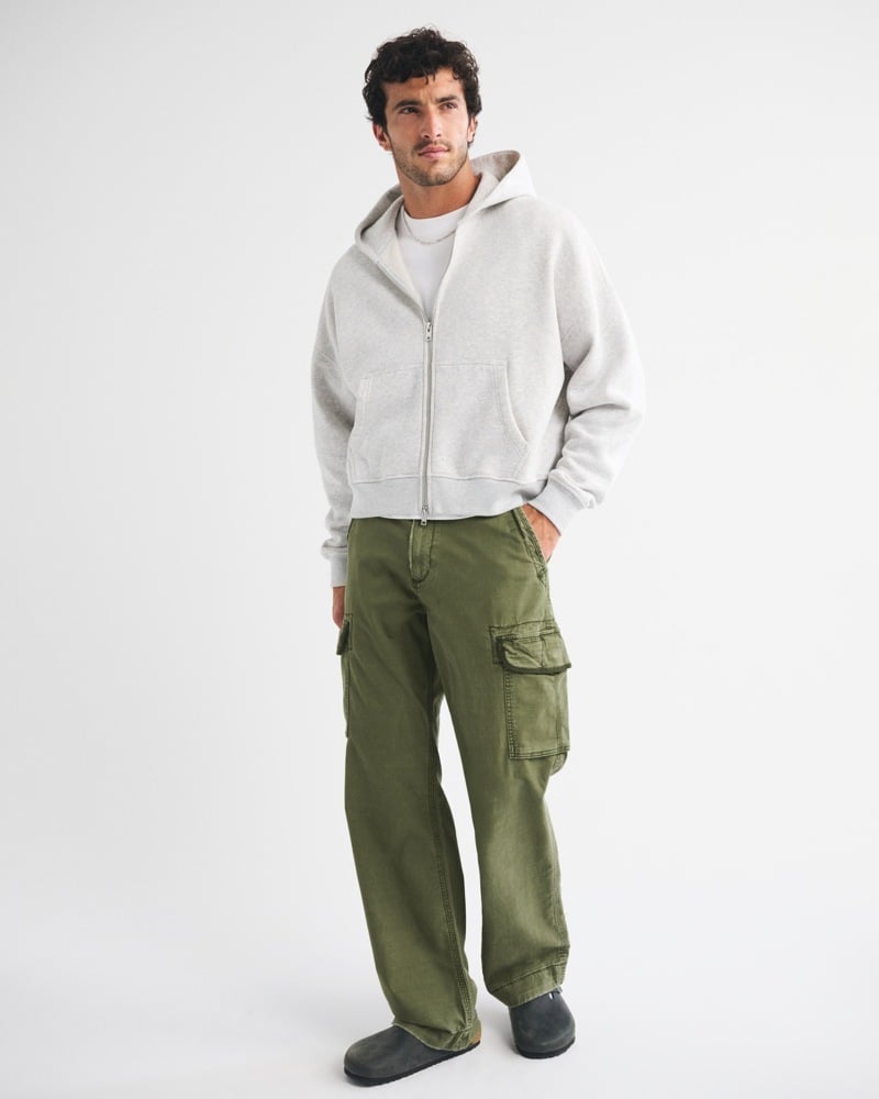 Gray zip hoodie, white T-shirt, olive baggy cargo pants and gray clogs from Abercrombie & Fitch.