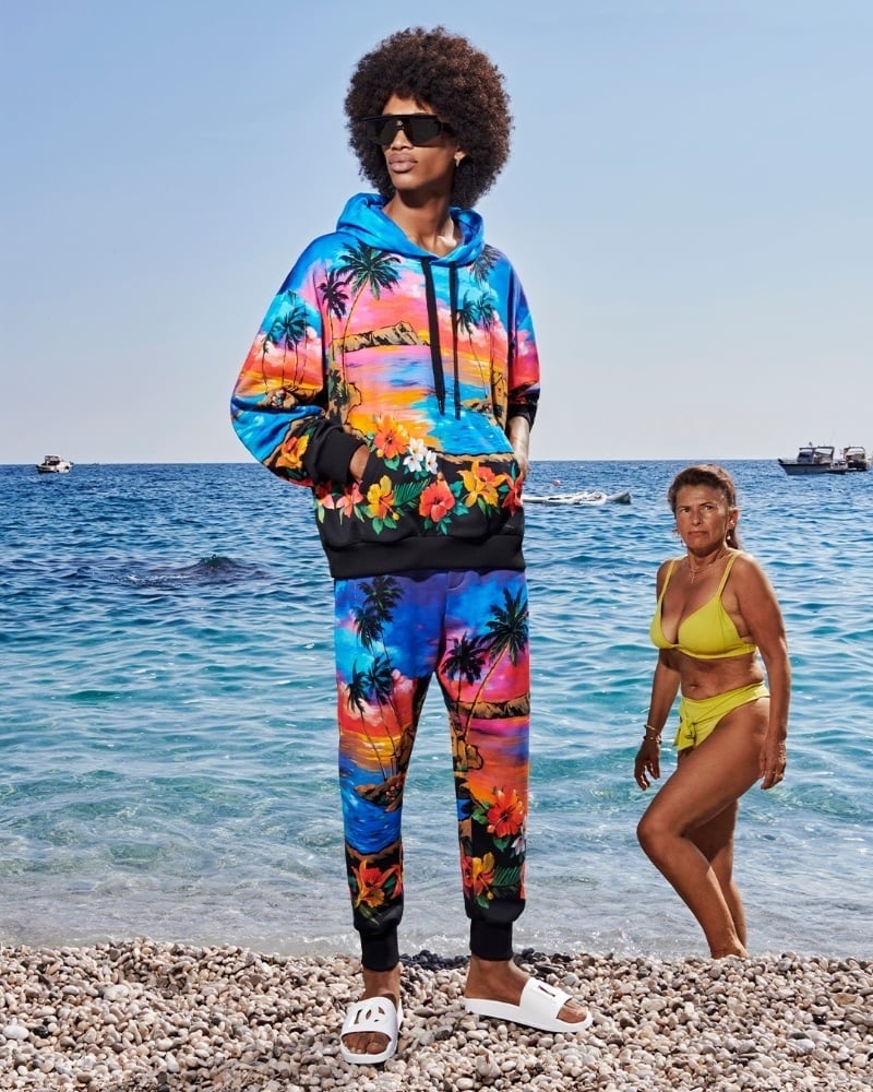 Dame Lo wears a matching tropical-print sweat set with white slides from Dolce & Gabbana’s spring-summer 2023 collection.