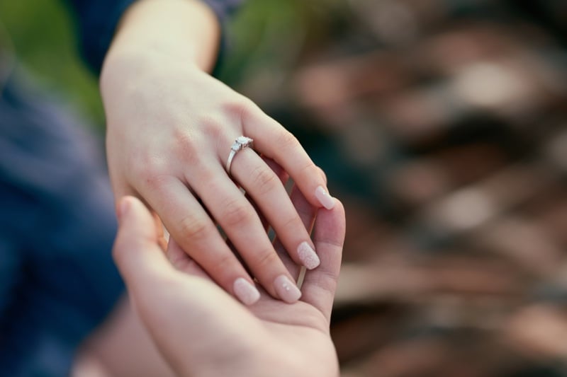 Engagement ring couple holding hands