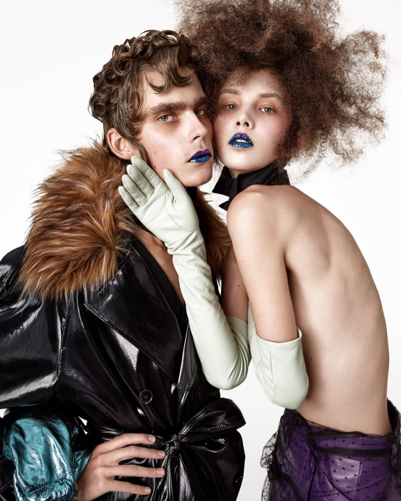 Close-up of Frederic Bittner in a glossy trench with a faux fur collar and Anna Bicanova in a black neck bow and long pale leather gloves