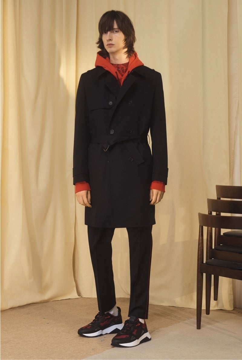 HUGO’s cruise 2020 lookbook combines a trench and hoodie with chunky sneakers.
