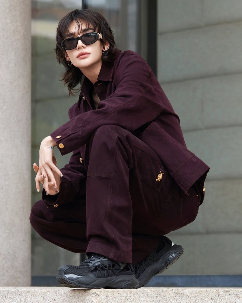 Hyunjin wears burgundy outerwear and sunglasses in Versace’s Mercury campaign.