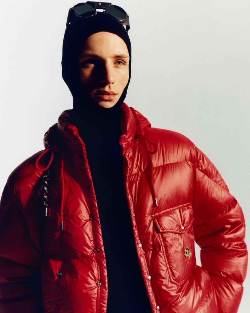 Indiana van't Slot in a glossy red Moncler puffer jacket and a knit balaclava with round goggles pushed up on top, one hand in his pocket