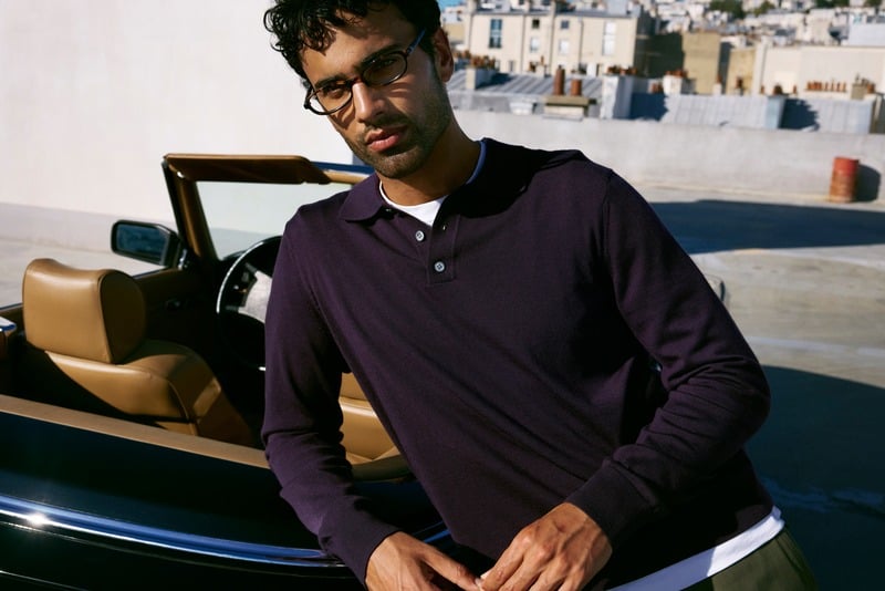 Jy Aoukar wears Jimmy Fairly Emmy glasses and a dark polo beside a convertible.