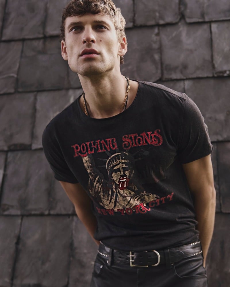 David Trulik wears a Rolling Stones graphic T-shirt with dark trousers for John Varvatos' fall-winter 2026 campaign